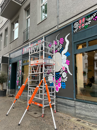 The exterior facade of Kira&rsquo;s Caf&eacute; with a half-finished artwork